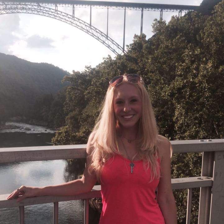 girl standing with new river gorge bridge in background