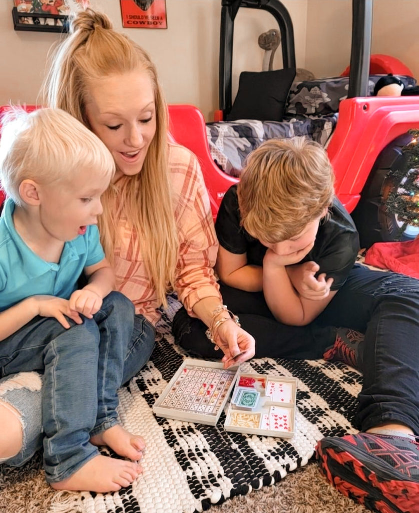 mother and two children playing brain-building gifts for kids Travel SEQUENCE game from Goliath together