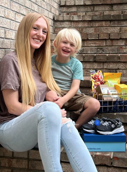 mom and son sitting on stairs with items next to them