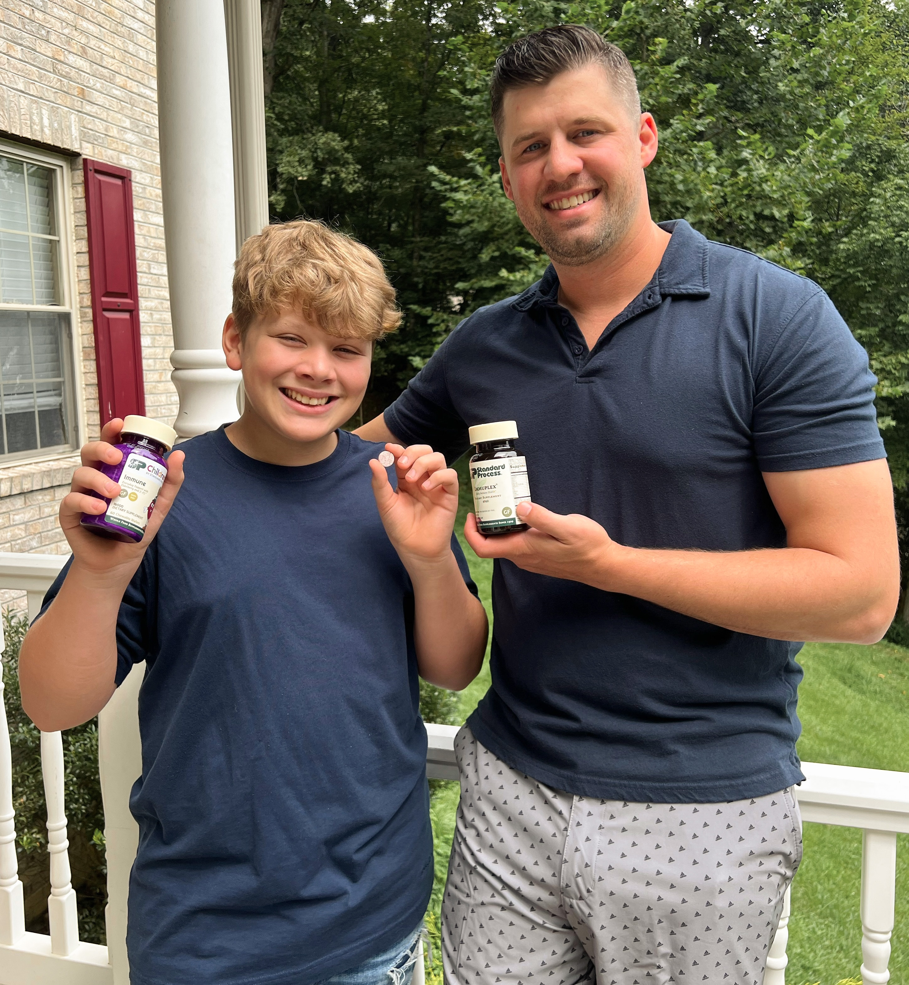 man and boy holding vitamins - back to school items